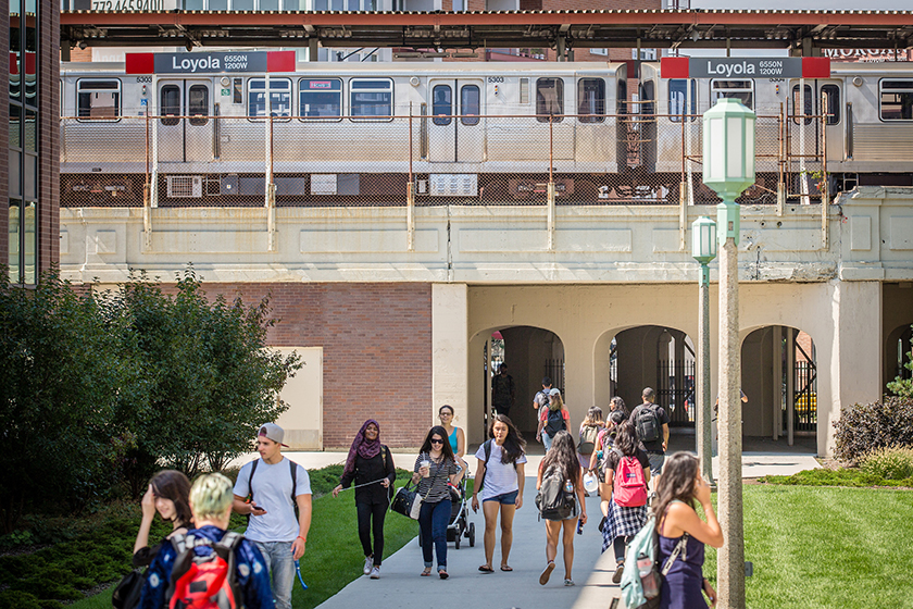 Students walk to class with the CTA El Train in the background