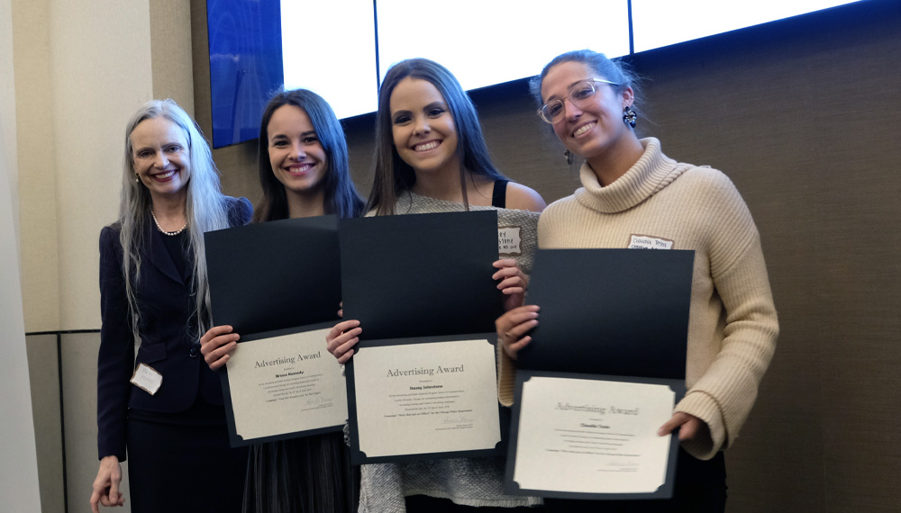 At a pre-pandemic ADPR Awards ceremony, Associate Professor Pamela Morris, Ph.D., left, presents awards to students Briana Kennedy, Stacey Johnstone, and Claudia Testa.