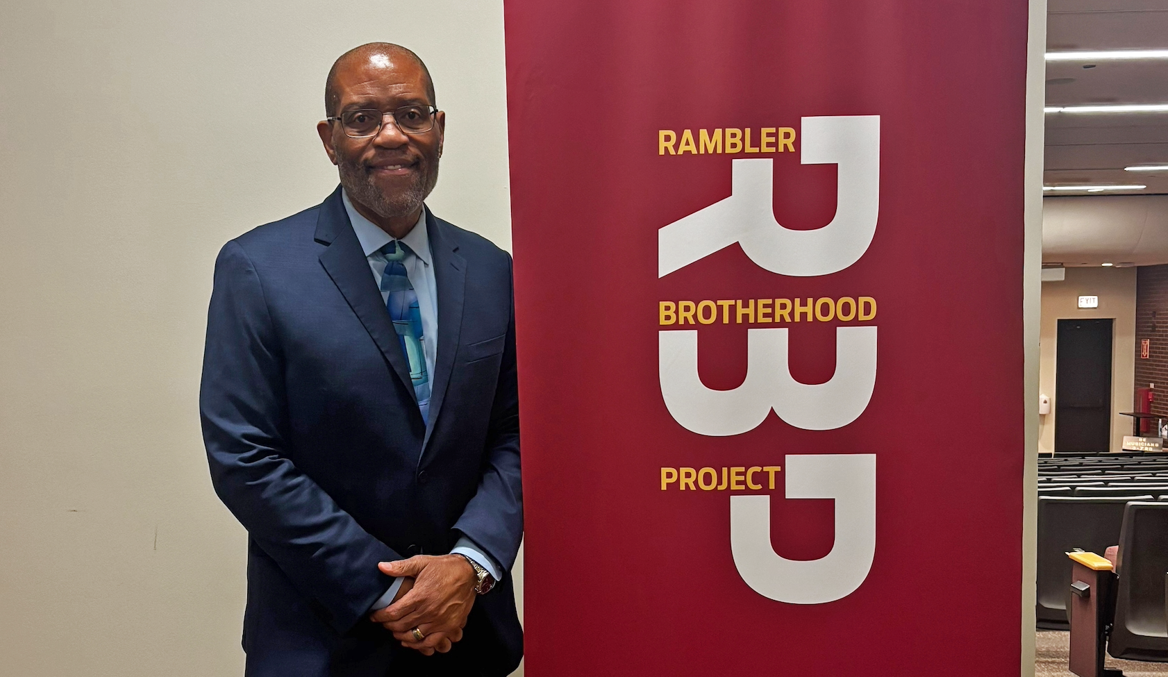 Harold Ellis Clark next to a Rambler Brotherhood Project sign. Harold Ellis Clark next to a Rambler Brotherhood Project sign.