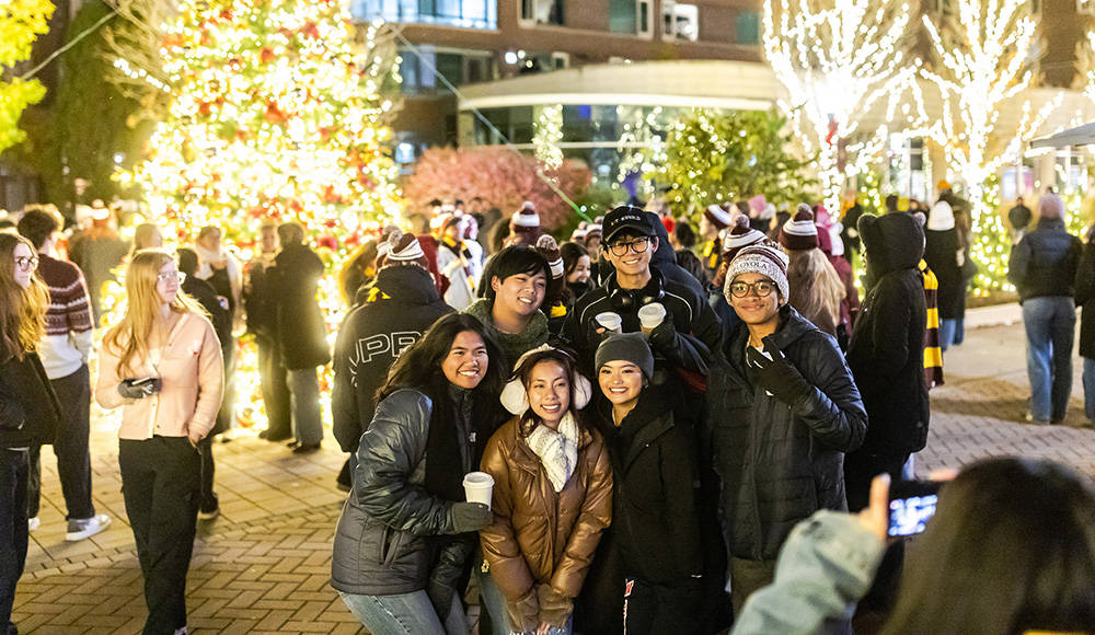 Students pose for a selfie in front of the lit Christmas tree at St. Ignatius Community Plaza. Students pose for a selfie in front of the lit Christmas tree at St. Ignatius Community Plaza.