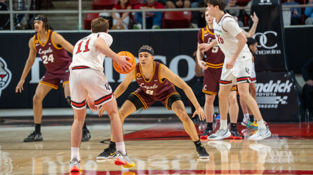 Loyola Men's Basketball member guarding a player.