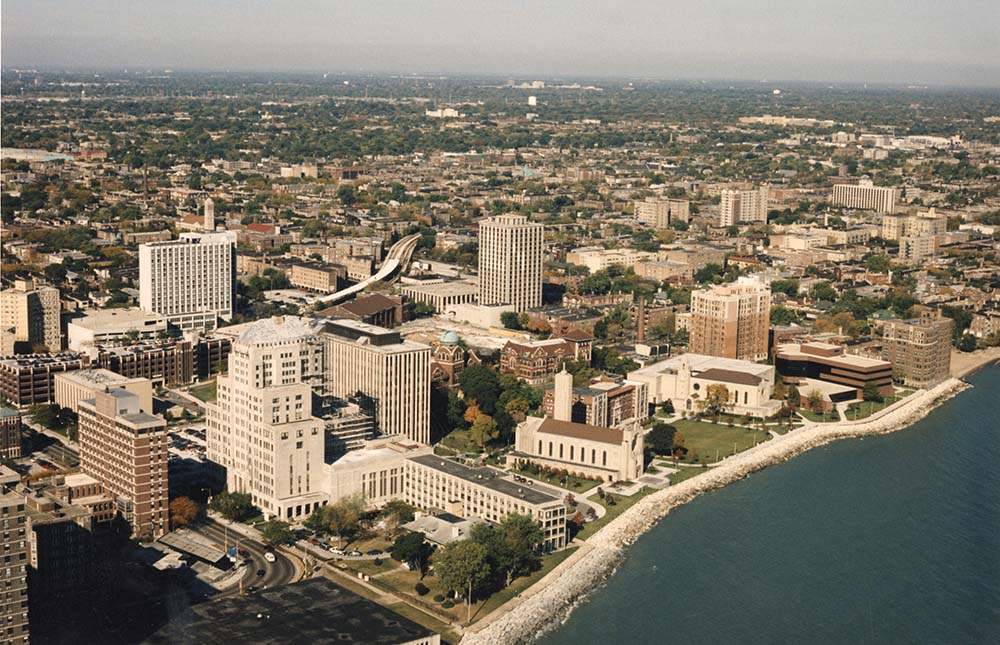 Aerial photograph of the Lake Shore Campus from Lake Michigan looking west in the 1990s