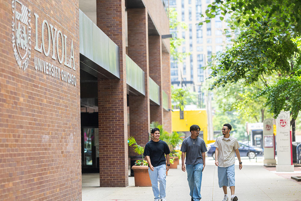 Arrupe Students walking in front of Maguire Hall