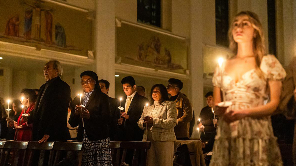 Parishioners Hold Candles at Mass