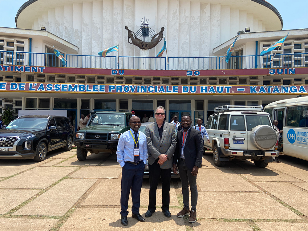 Dean Schraeder with Father Murhula and Kafarhire outside of regional parliament