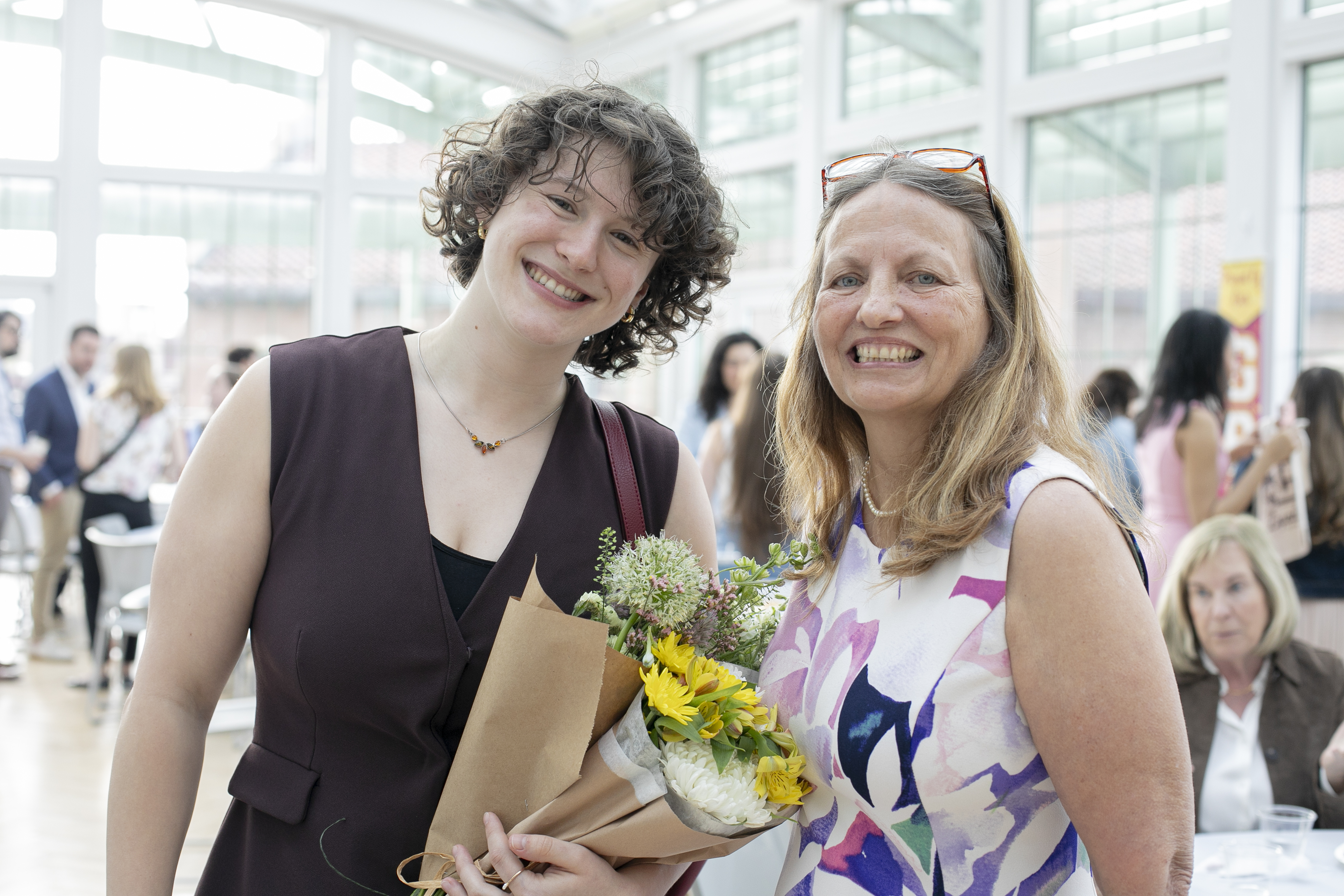 Margaux Kenney, winner of Outstanding PSCJ Minor Student Award, holding flowers and posing with Dr. Stalans
