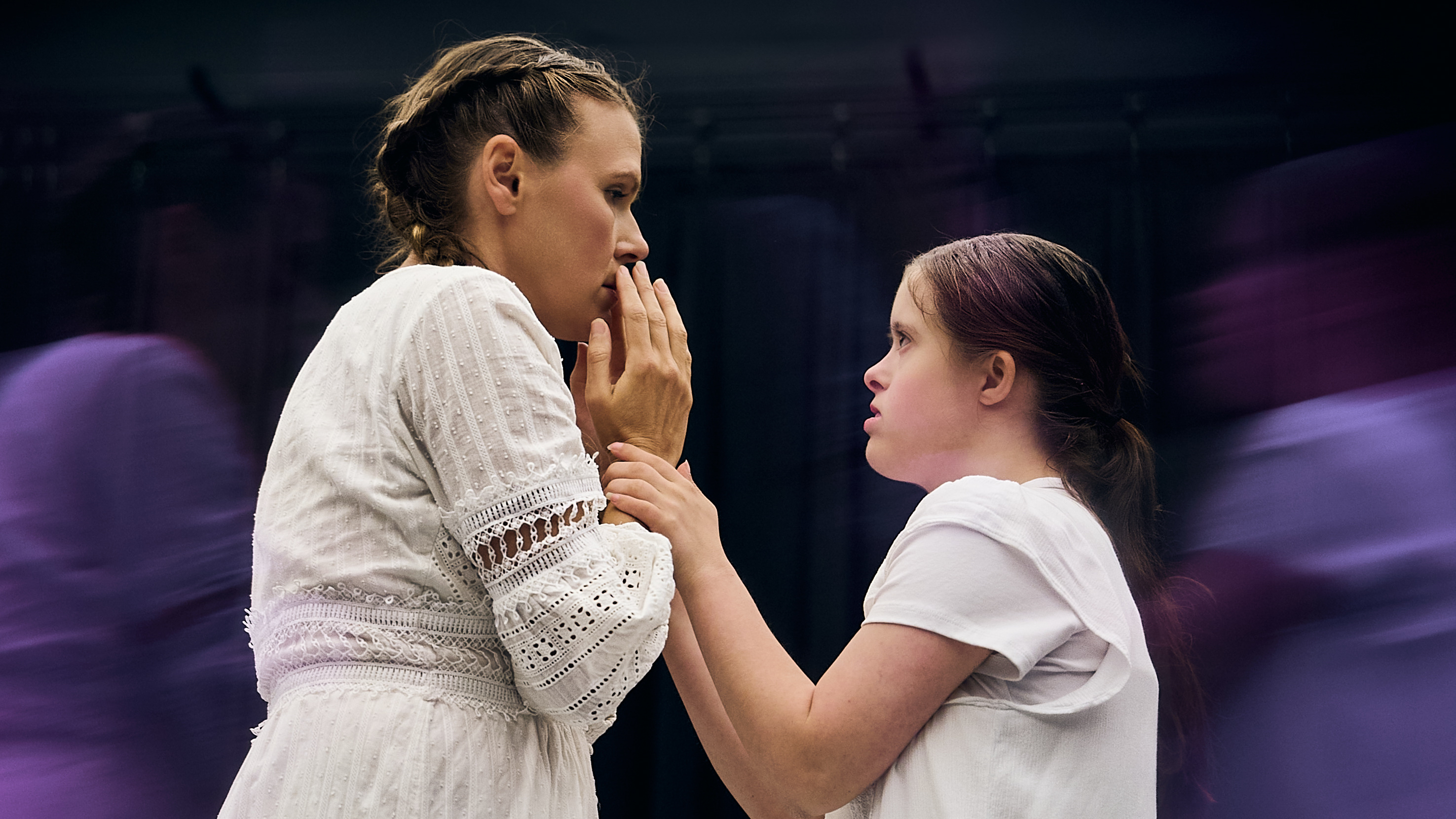 Two dancers face to face with one holding their others wrists performing And Yet We Are Here Two dancers face to face with one holding their others wrists performing And Yet We Are Here