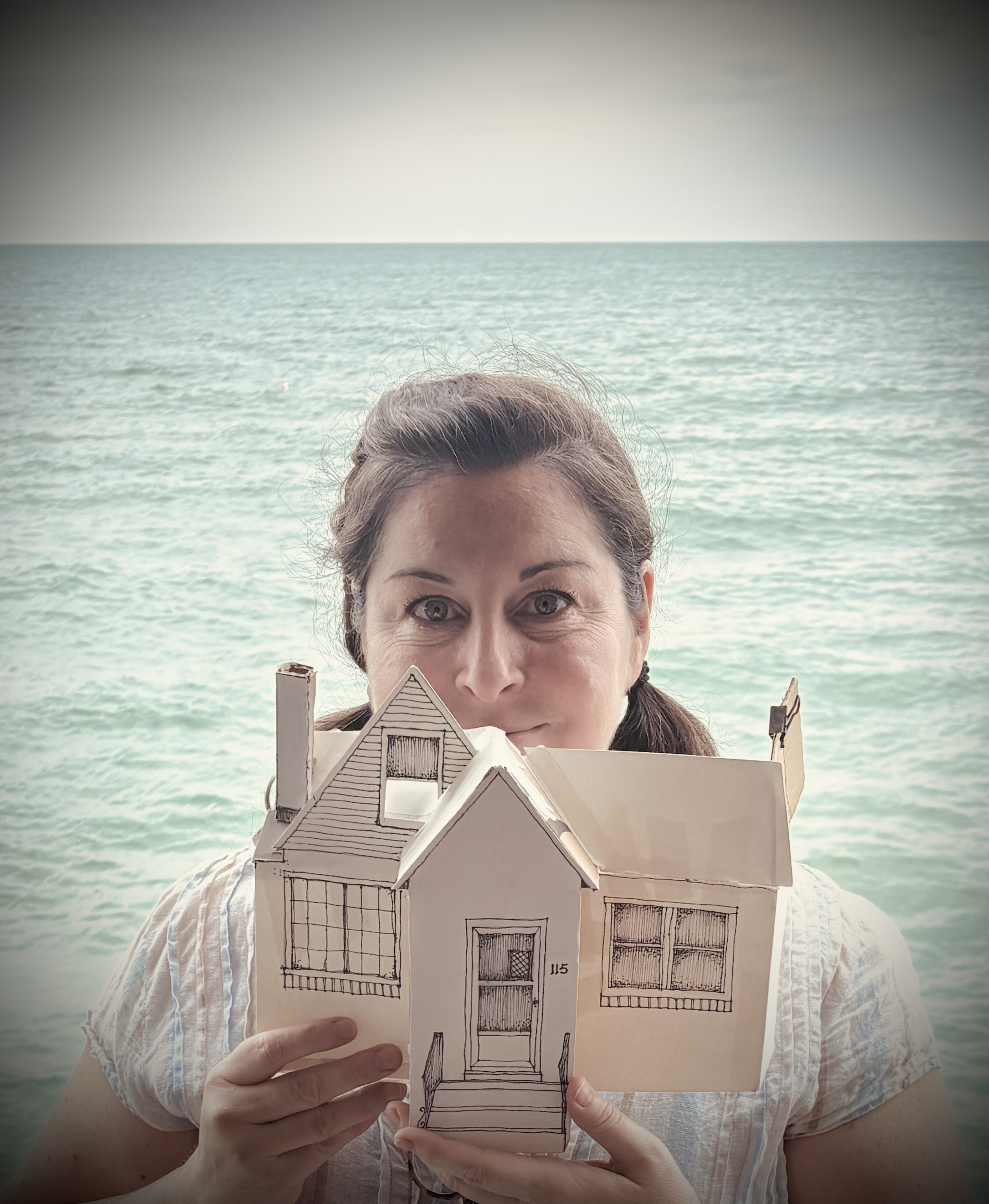 Loyola Faculty Member Rachel Healy holding a prop house