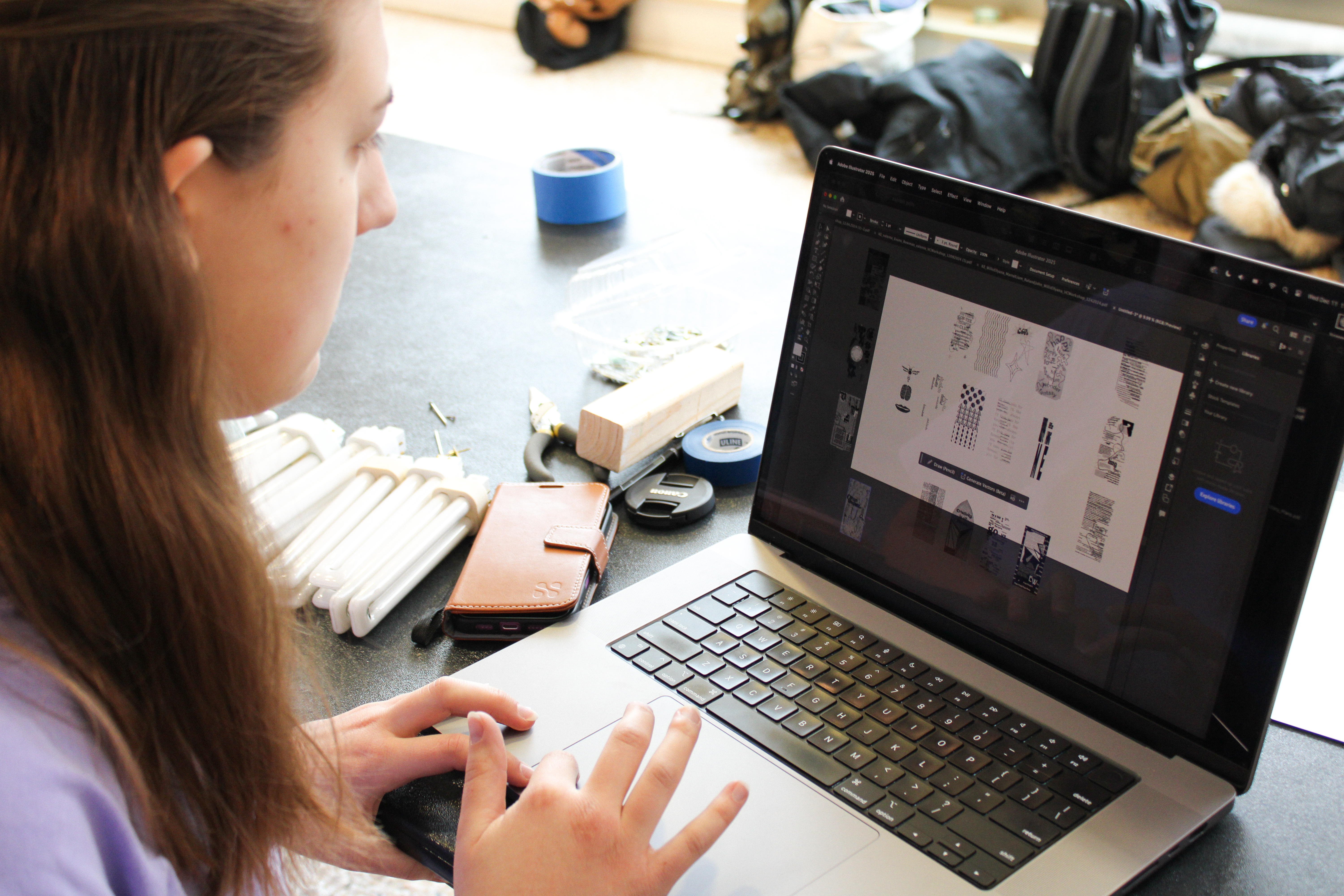 Loyola Visual Communications Student working on a laptop