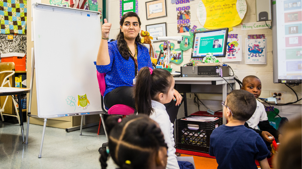 Armeen Sayani is sitting in class with students