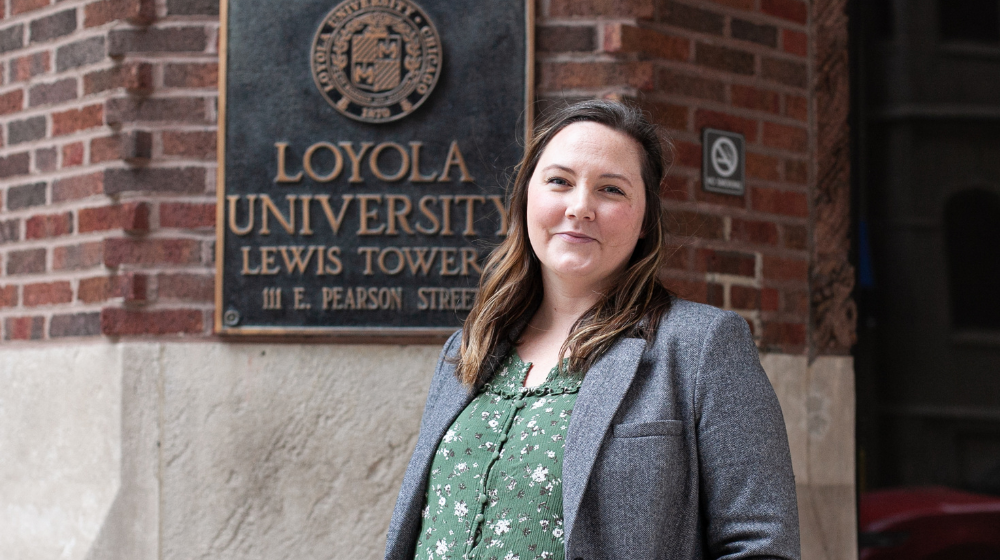 Ashley Mayworm stands in front of Lewis Tower