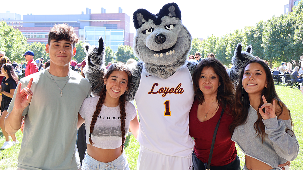 A family poses with LU Wolf at the Family Weekend picnic.