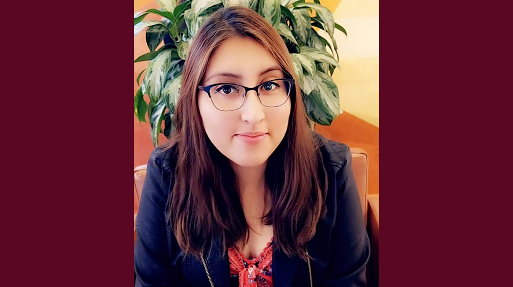 Headshot of a brunette person with glasses Headshot of a brunette person with glasses