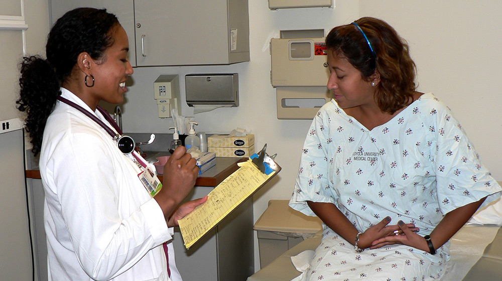 A medical student practices exam procedures on a training participant