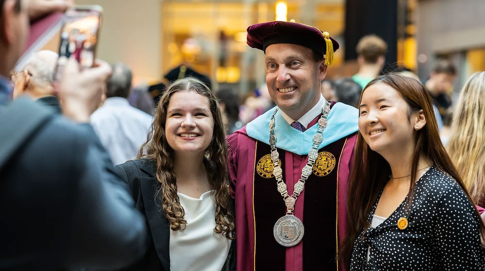 New President Dr. Mark C. Reed with student at his inauguration