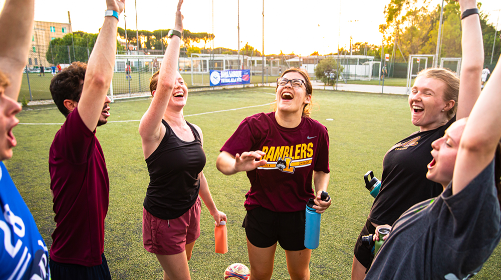 Loyola students huddle up during a game of soccer