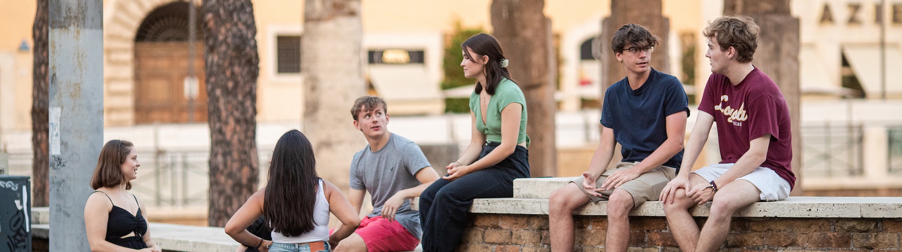 Students sit in piazza in downtown Rome