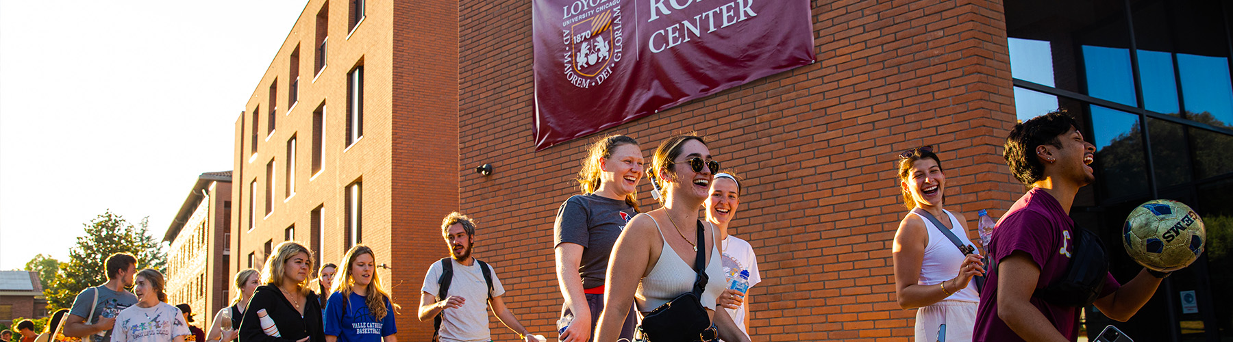 Students walk next to the Rome Center on campus