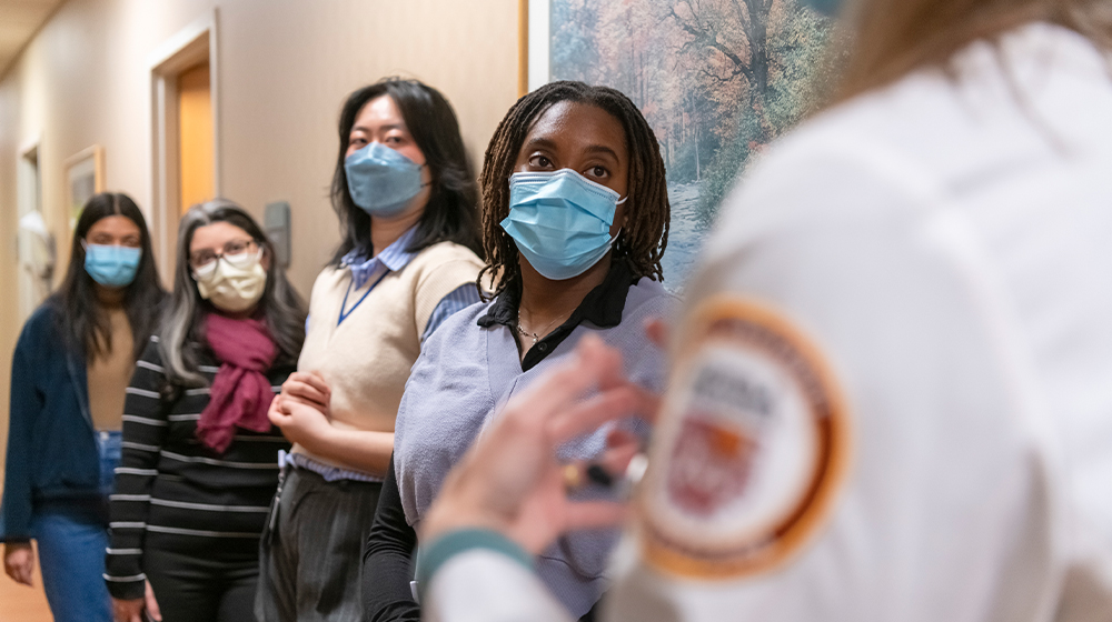 Health Justice Project students listening to a doctor