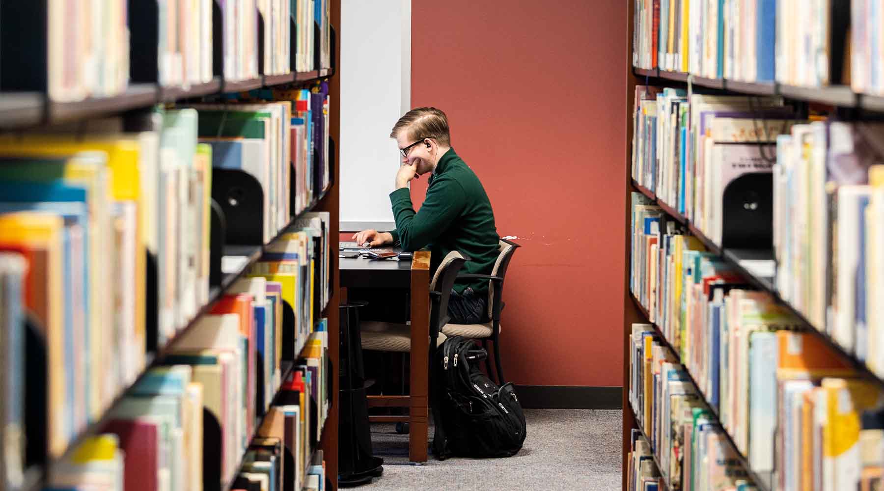student in Corboy library