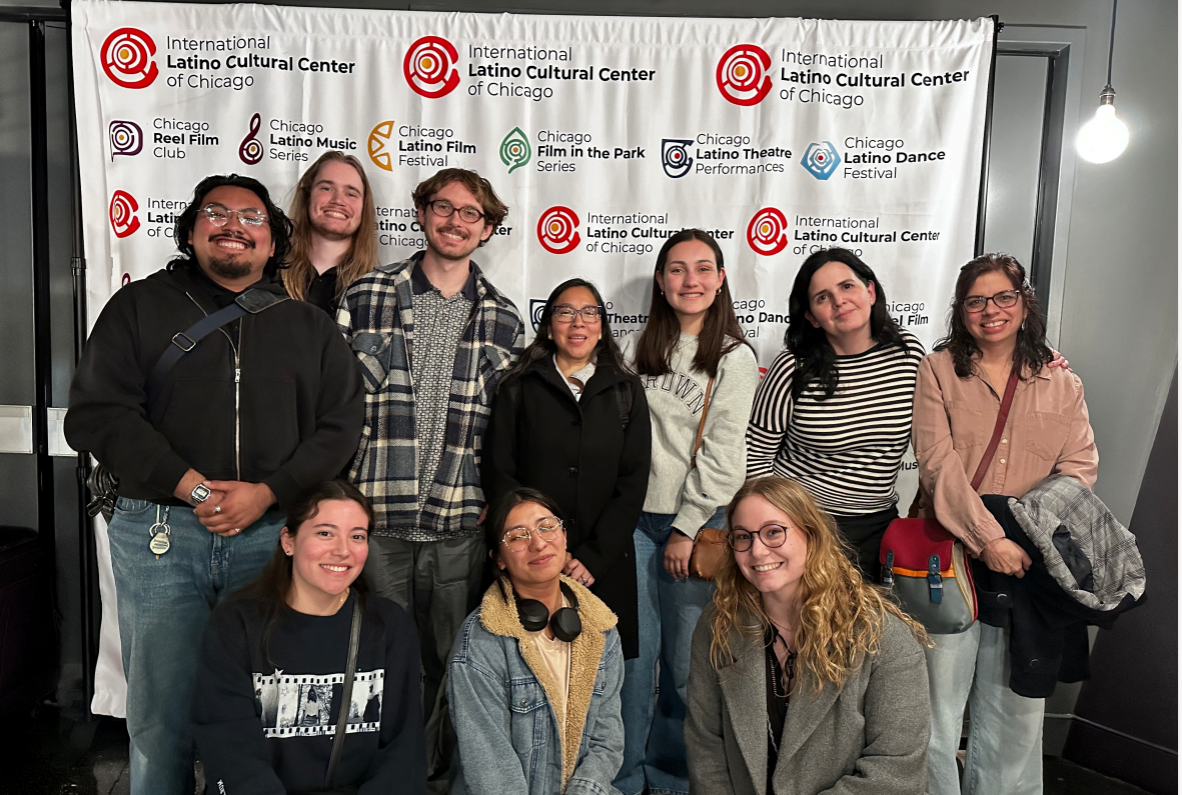 ten students smiling infront of Chicago latin film backdrop
