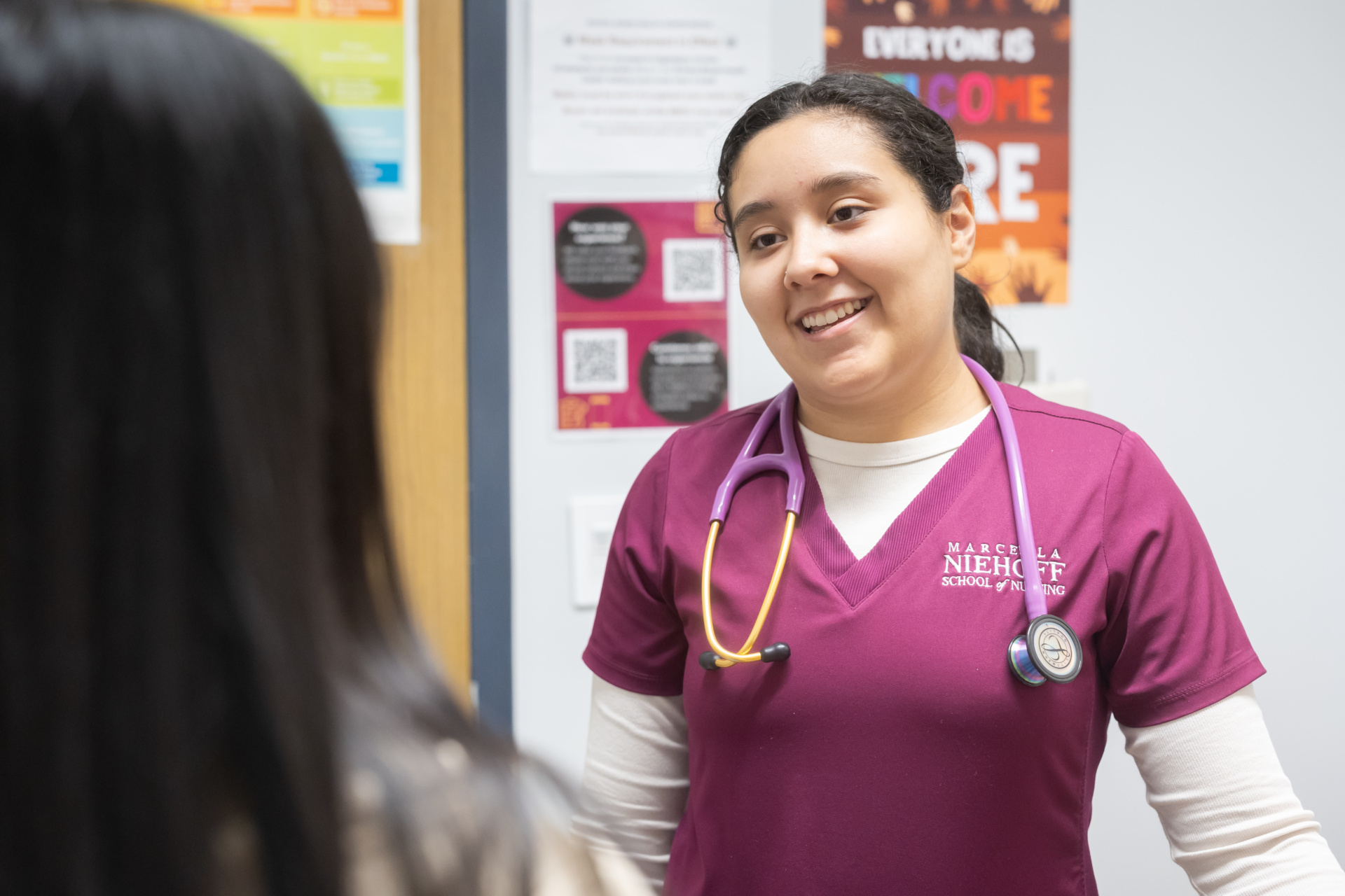 A Loyola Nurse speaking to a patient
