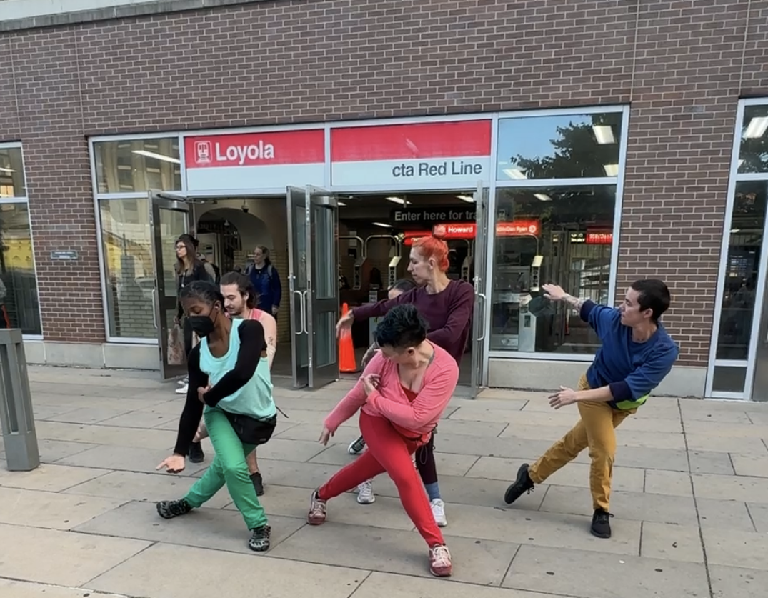 dancers at the Loyola Redline CTA station in multicolored clothing