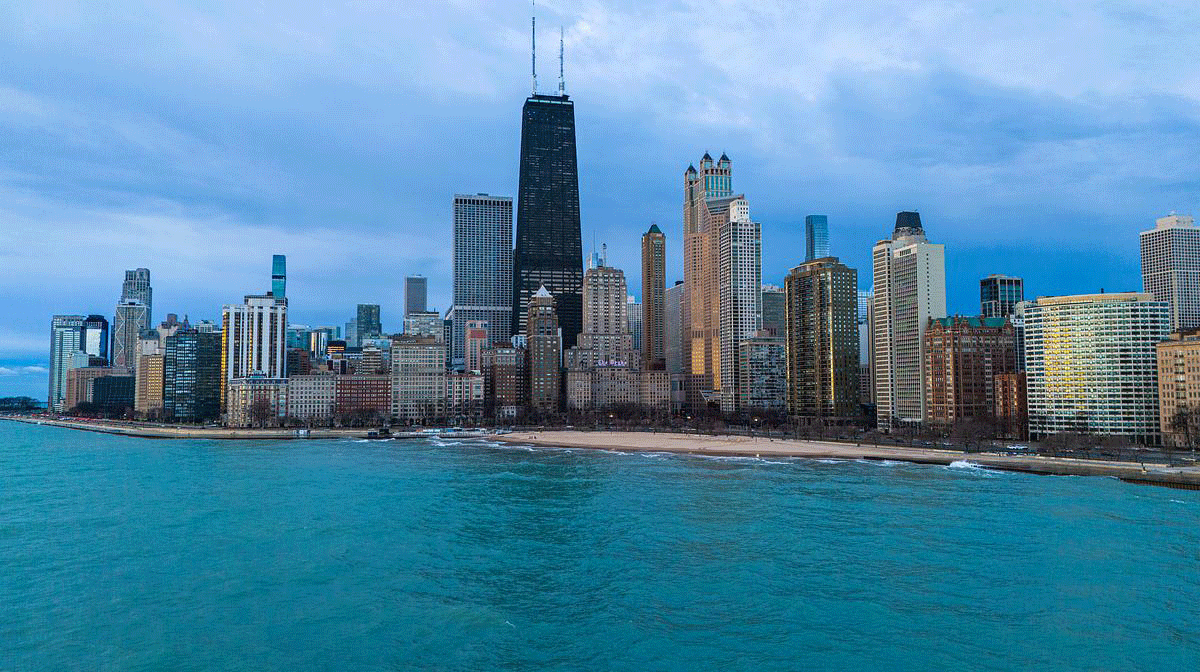 The skyline of downtown Chicago behind a turquoise blue Lake Michigan The skyline of downtown Chicago behind a turquoise blue Lake Michigan