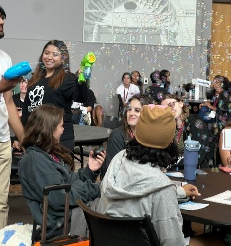 Workshop in progress with students celebrated with bubbles for correct answers