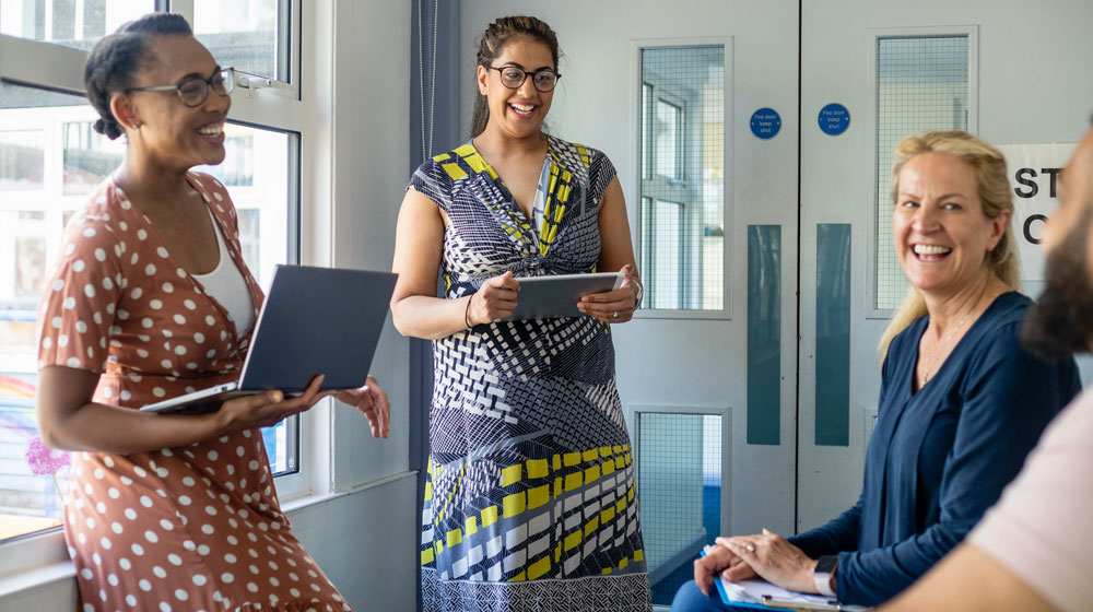MTSS teachers with tablets in conversation