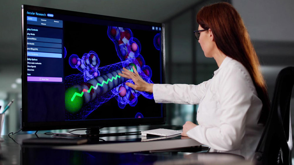 scientist analyzing a 3D molecular model on a monitor
