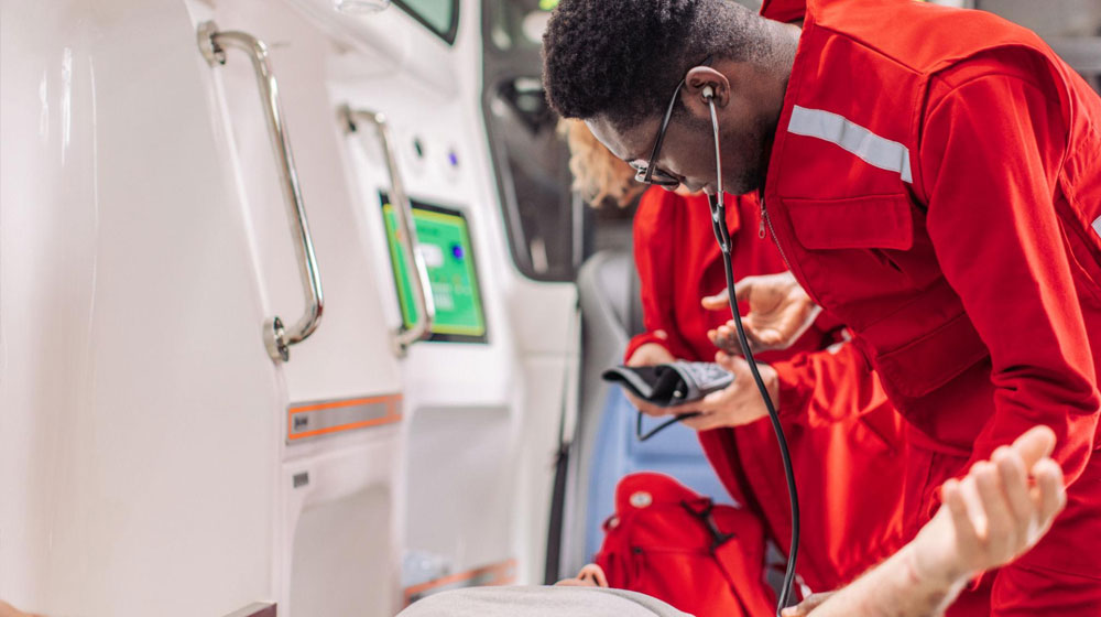 Paramedic checking patient