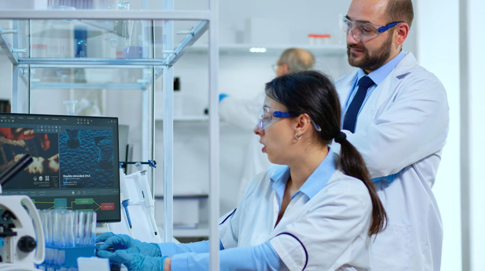 lab researchers working at a computer