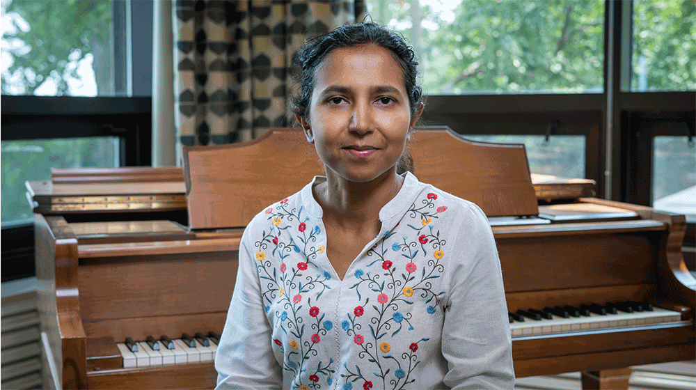 Chakraborti is sitting in front of a piano Chakraborti is sitting in front of a piano