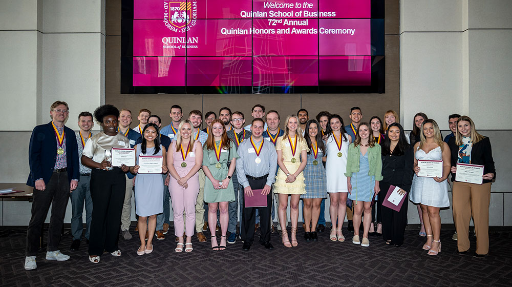 Group of students standing with their awards Group of students standing with their awards