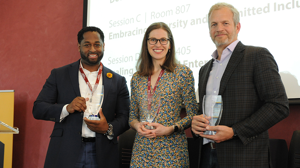 Representatives from Chobani, Bain Capital Double Impact, and Indigo Ag holding glass awards. Representatives from Chobani, Bain Capital Double Impact, and Indigo Ag holding glass awards.