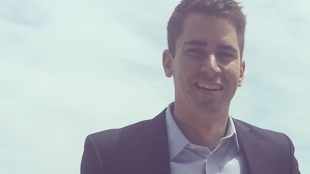 Young man wearing a suit, smiling at the camera Young man wearing a suit, smiling at the camera