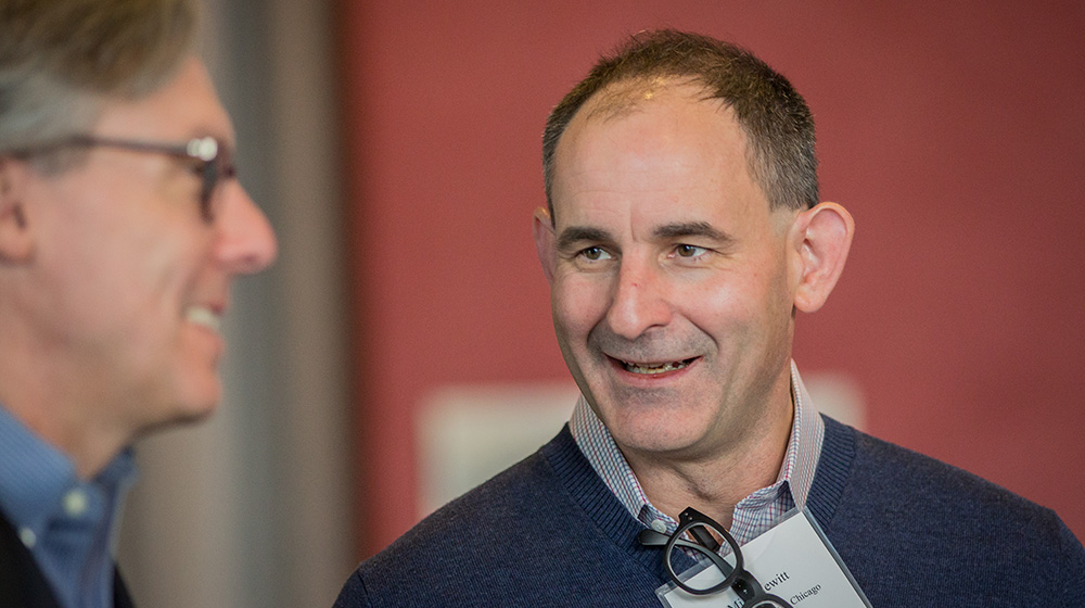 Professor Mike Hewitt chatting with an event attendee