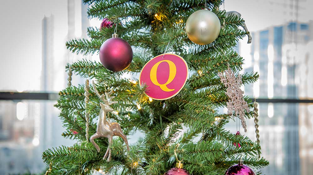 A close up of a Christmas tree decorated with red and silver ornaments