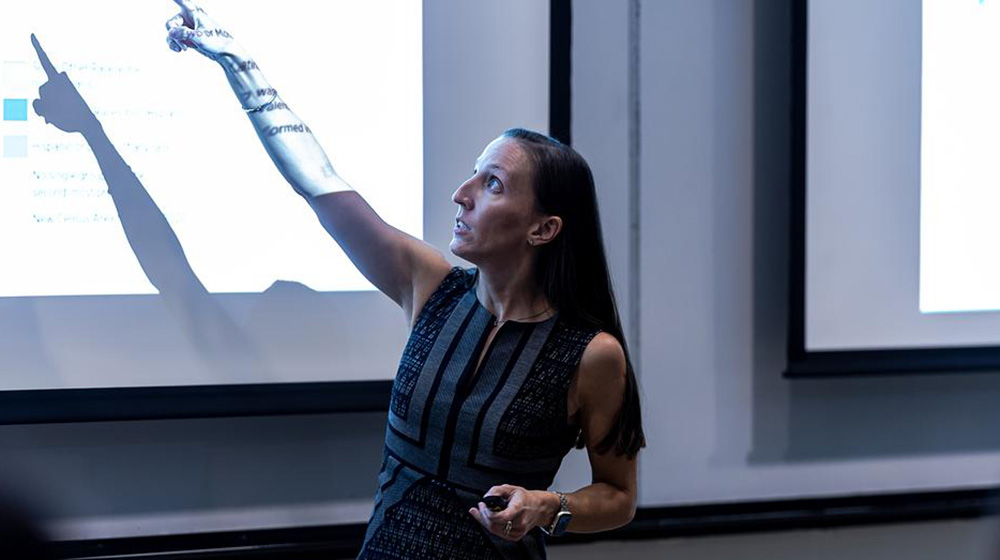 Brittney Bauer points at a projection