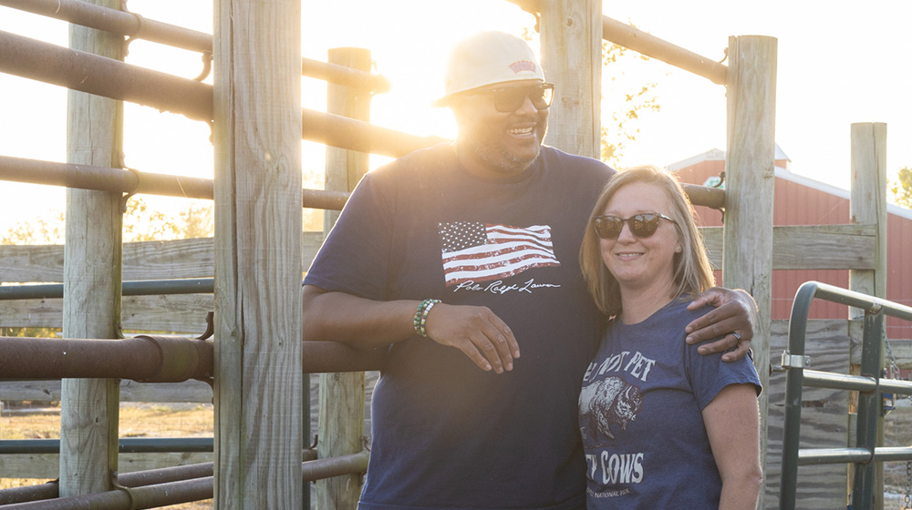 Phillip and Jennifer Rowel laugh by a fence