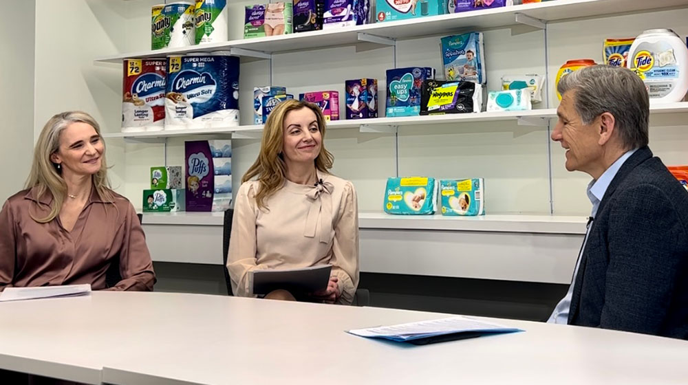 Linda Tuncay Zayer (center) sits with TCU collaborator Catherine Coleman (left) and Proctor & Gamble Chief Brand Officer Mark Pritchard (right).