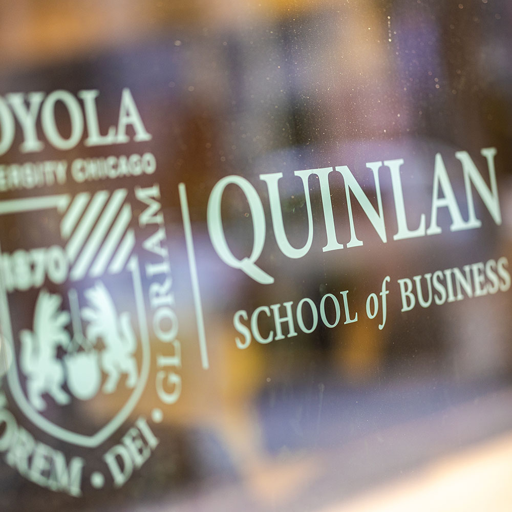 The Quinlan School of Business logo on a Schreiber Center window