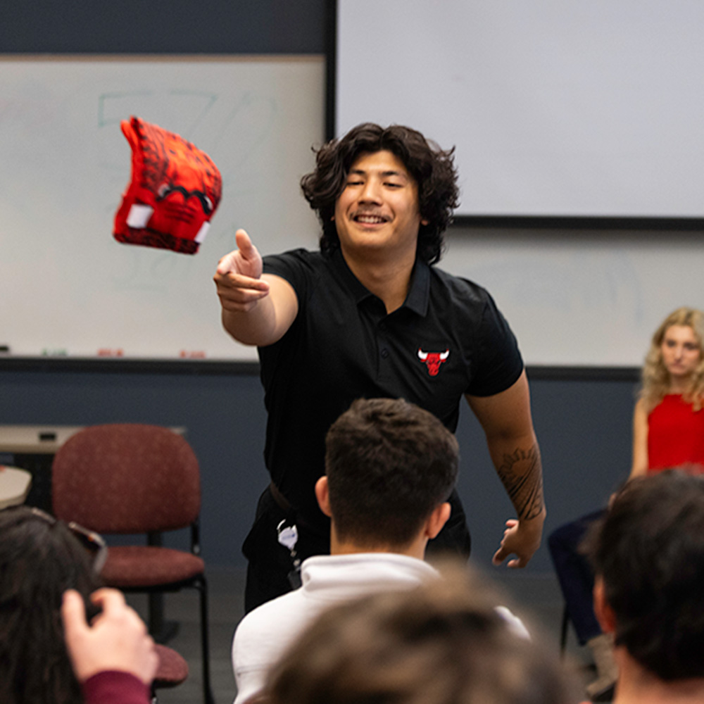 Aidan Alandy tosses a tee shirt to a student