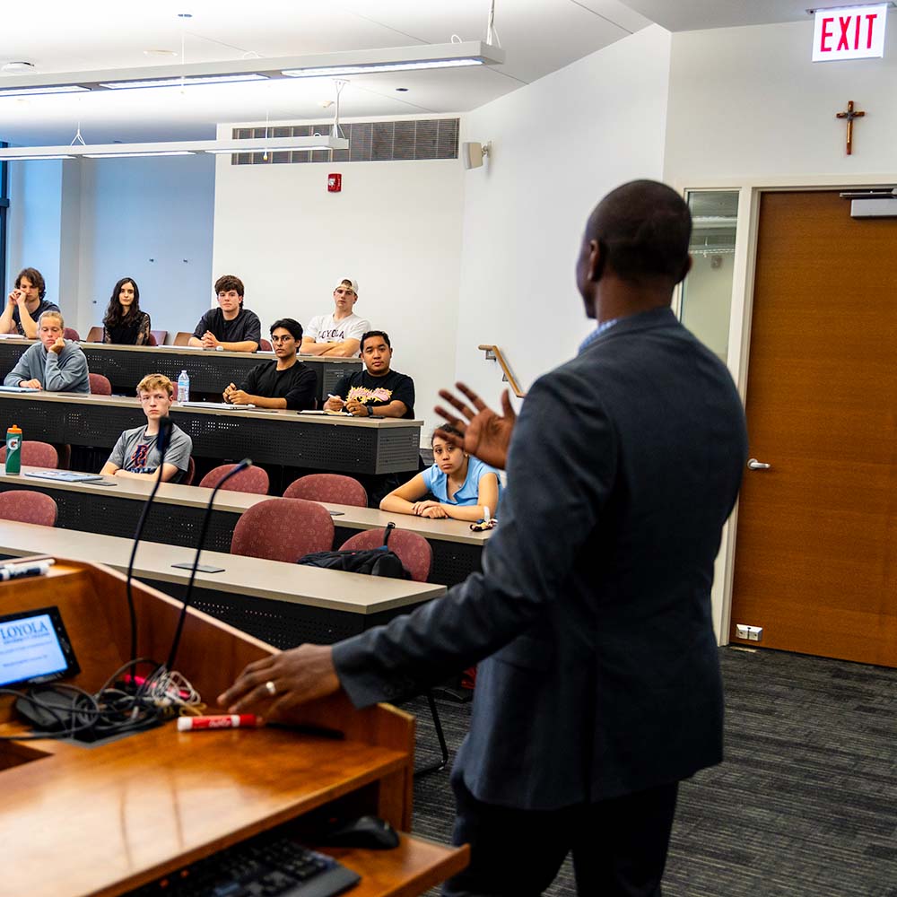 Andrew Coombs speaks to a classroom