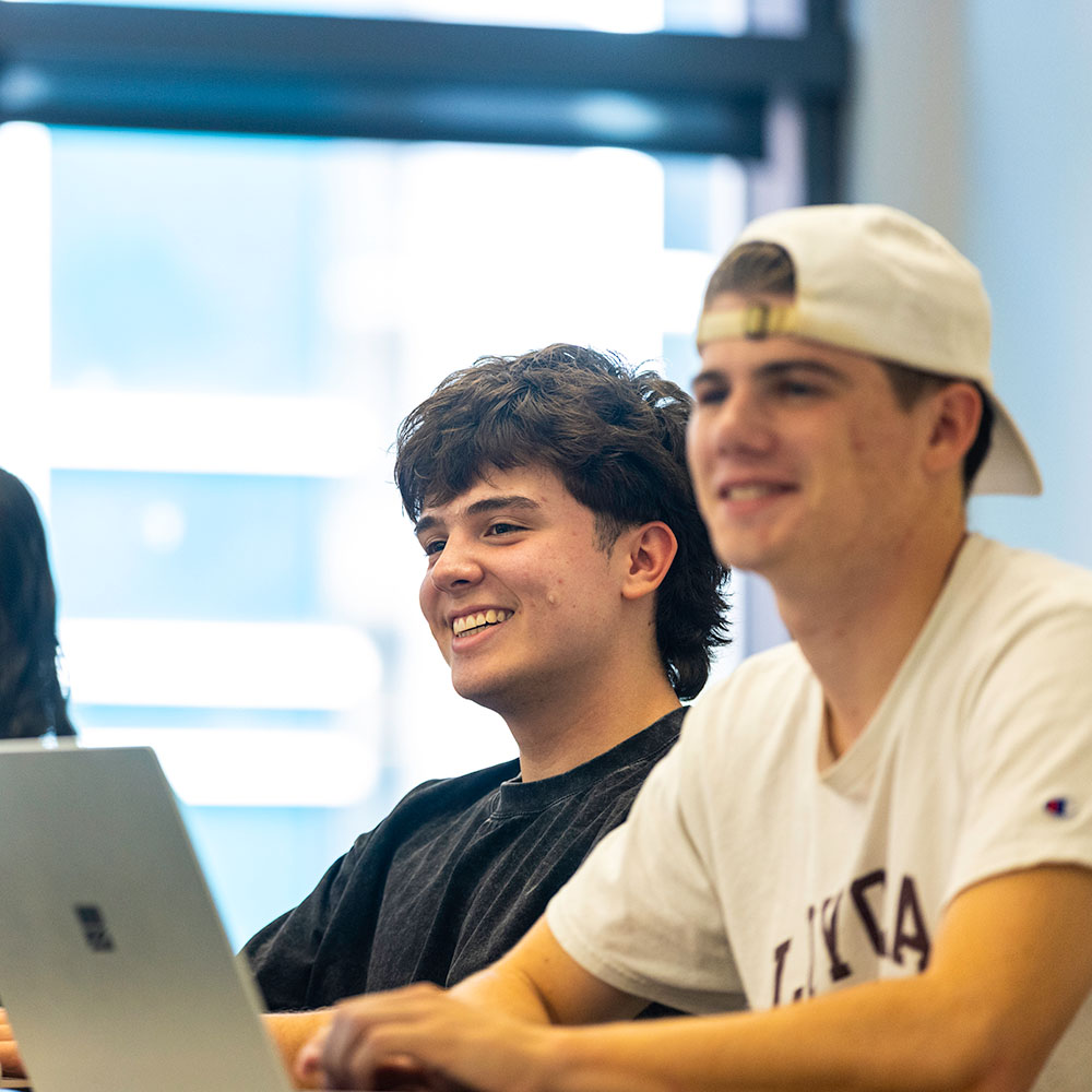 A student smiles in a classroom