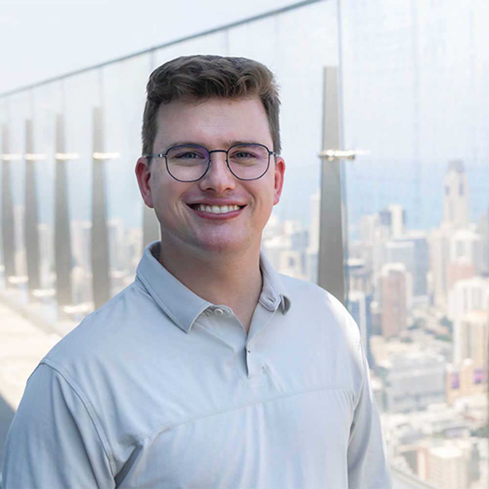 Headshot of John Duffy over the Chicago skyline