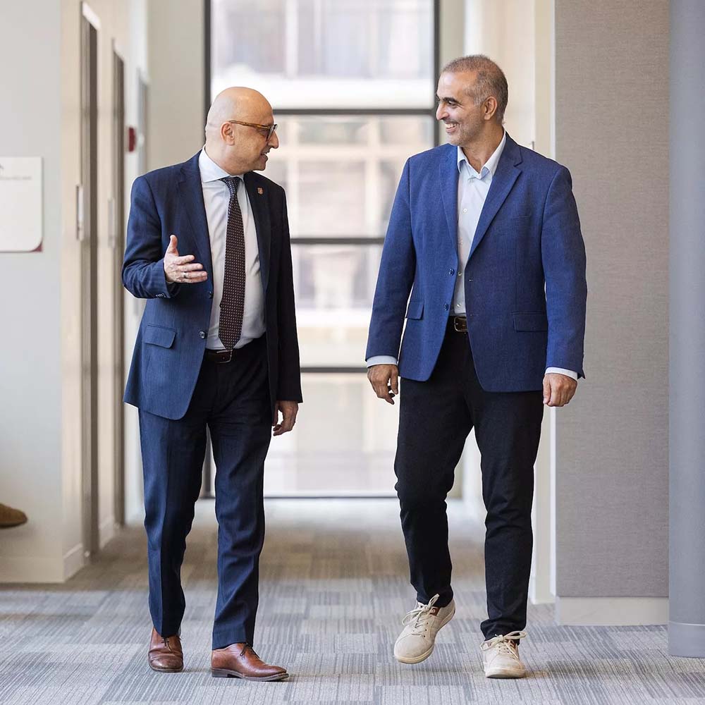 Pablo Di Si walks with dean Michael Behnam
