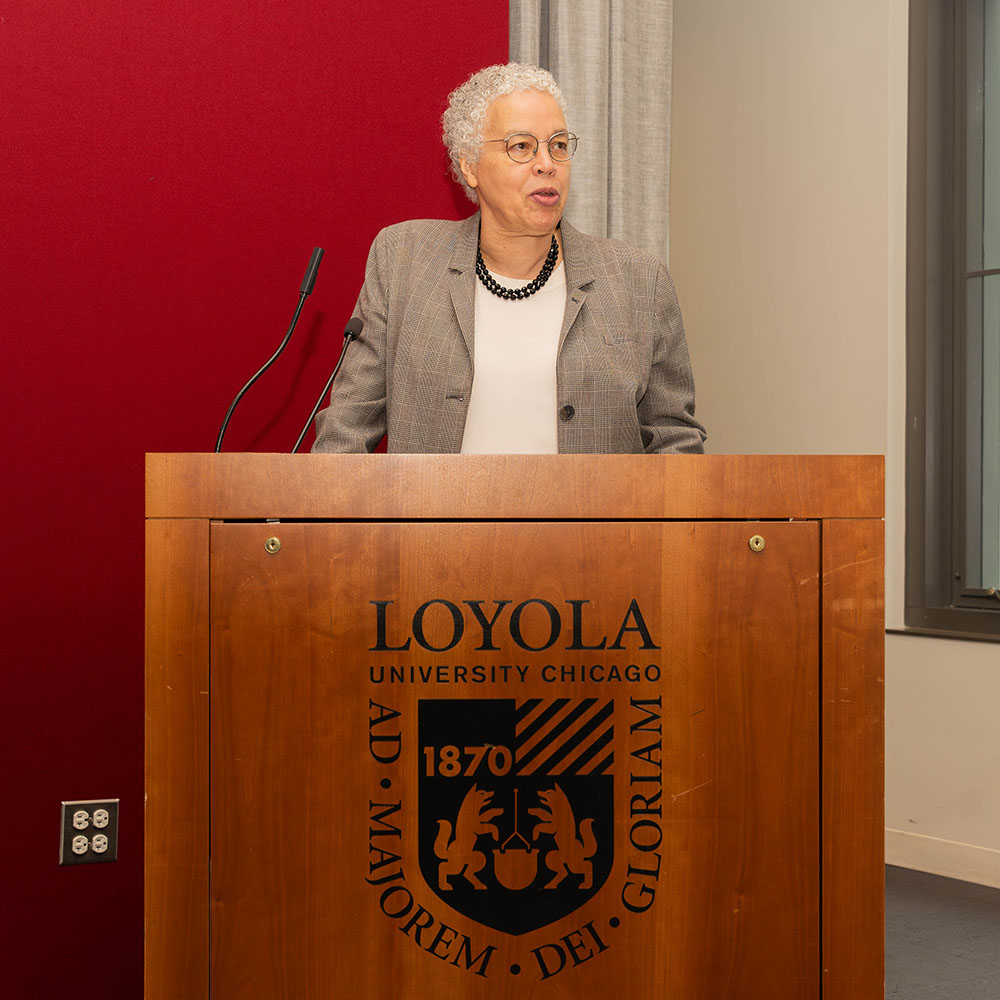Toni Preckwinkle stands in front of Loyola University Chicago podim