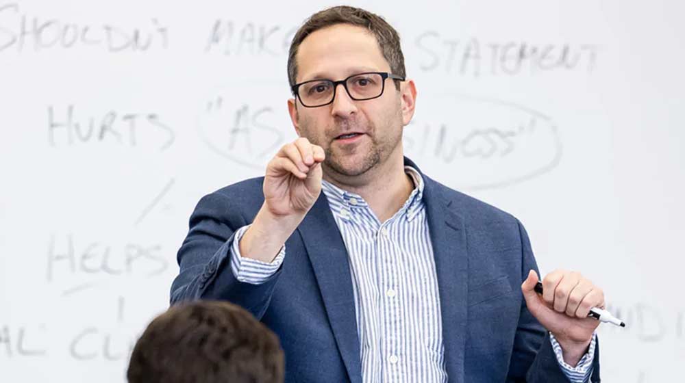 Professor Abe Singer lecturing in the classroom.
